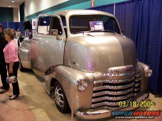 silver vintage Chevrolet truck with chrome grille and custom wheels