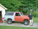 1981 Ford Bronco - A man stands next to a two-tone Ford Bronco that appears to be undergoing restoration.