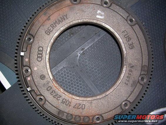 Rusty metal ring with gear teeth, marked "GERMANY", "AUDI", "027 105 273 D", and "FUS 35"