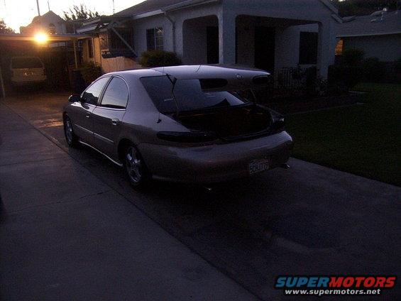 1998 Mercury Sable sedan with spoiler, trunk open, parked in driveway