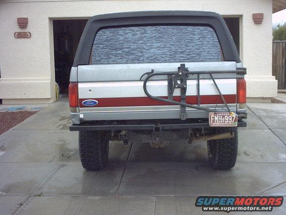 Silver 1990 Ford Bronco rear view with spare tire carrier and Arizona license plate FMH:997