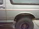 1990 Ford Bronco - This Ford Bronco has a two-tone paint scheme with a red pinstripe detail.