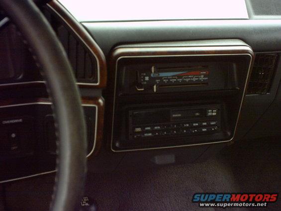 Interior shot of a vehicle's dashboard with a stereo and climate controls