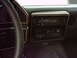 1990 Ford Bronco - The dashboard features wood grain trim around the radio and climate control panel.