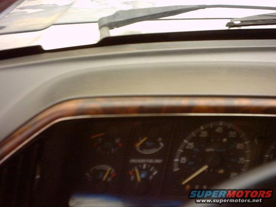 1990 Ford Bronco interior dashboard with wood trim and gauges