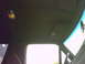 1990 Ford Bronco - Interior view of vehicle ceiling with sun visors and a hanging object.