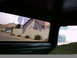 1990 Ford Bronco - View from inside a vehicle shows a suburban street scene through the side windows.