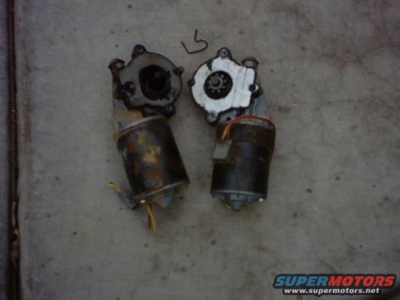 Two windshield wiper motors on concrete