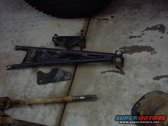 Suspension control arm, axle shaft, and differential cover on concrete floor