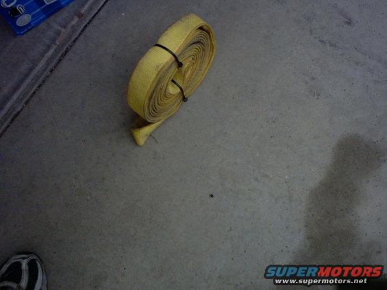 Rolled yellow tow strap on concrete floor