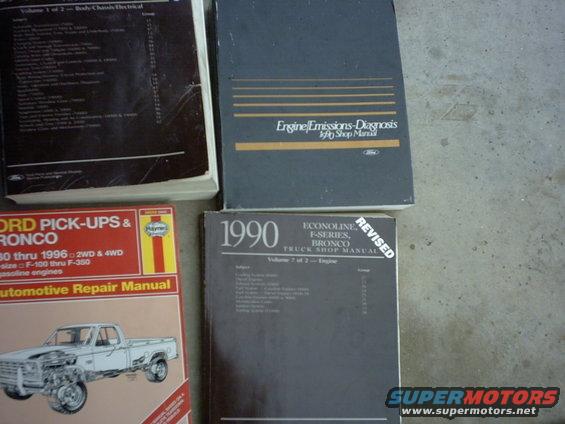 Four automotive repair manuals, one labeled 1990 Ford Bronco Truck Shop Manual