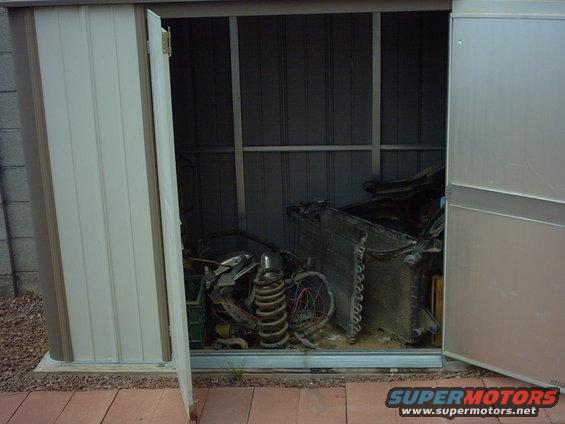 Car parts including a radiator and coil spring stored in a shed