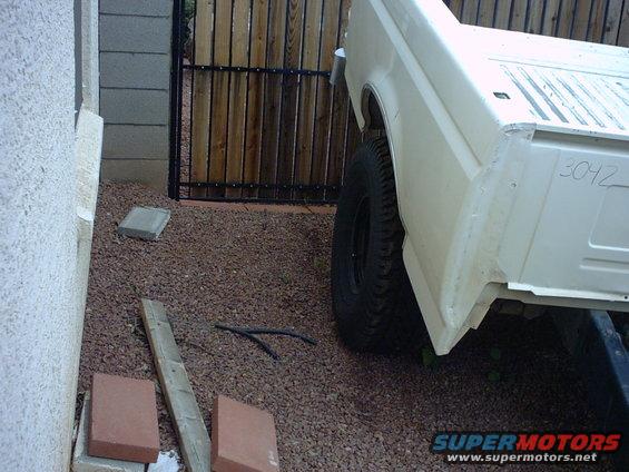 White pickup truck rear quarter panel with number 3042 written on it