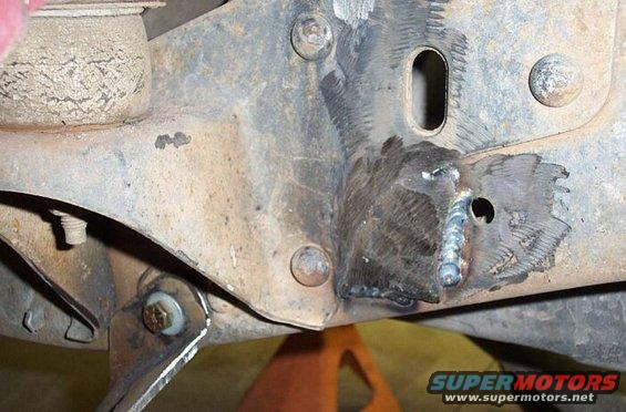 The hanger would need to bolt on an uneven area of frame here, so I welded in some scrap and ground smooth
