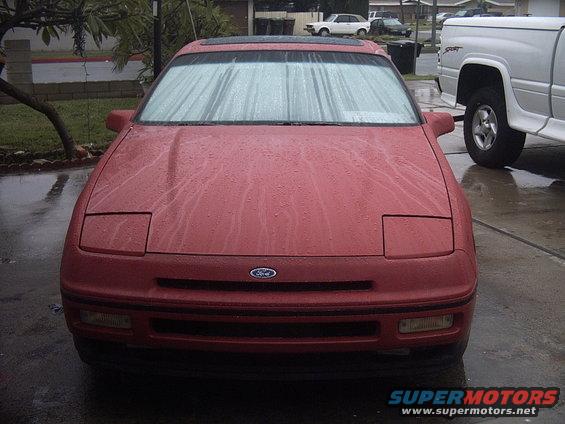 Red 1989 Ford Probe with pop-up headlights and a sunroof, viewed from the front