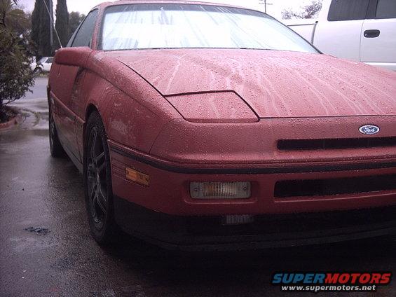Red 1989 Ford Probe front view with pop-up headlights