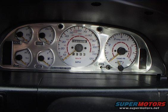 Car dashboard with voltmeter, temperature, oil, fuel, speedometer, and tachometer gauges. Odometer shows 54167 miles