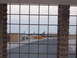 1988 Ford Bronco - Multiple airplanes are visible on an airfield, seen through a barred window.