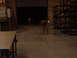 1988 Ford Bronco - Two individuals are visible in a dimly lit warehouse setting, one near an open bay door.