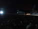 1988 Ford Bronco - A large military cargo plane sits on a tarmac at night, illuminated by ground lights.