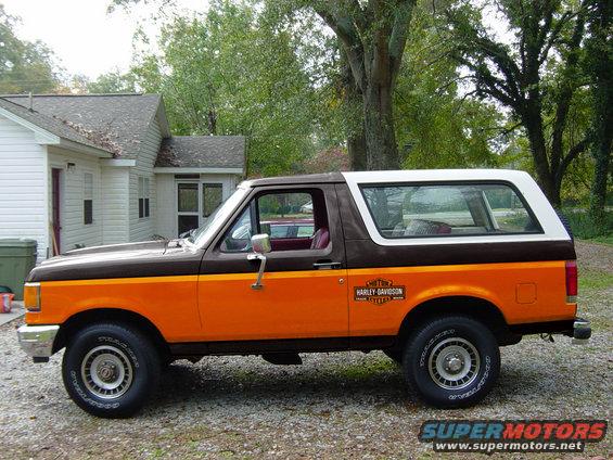Brown and orange Ford Bronco with Harley-Davidson decal, side view