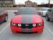 1978 Ford Mustang II - Front view of a red 2005 Ford Mustang with dual black racing stripes.