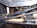 1974 Ford Bronco - Close-up of the undercarriage, focusing on the suspension and steering components of an off-road vehicle.