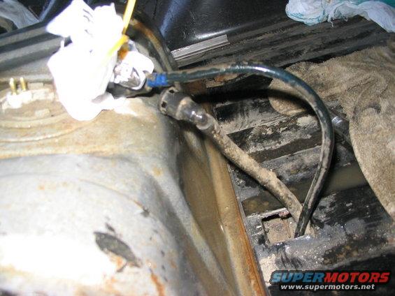 gas-tank-tow-hitch-bumper-013.jpg Cut up through the cross member for the fuel lines .. there was a hole in it already on the bottom .. just had to cut out the top with the grinder