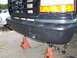 1994 Ford F-150 - Front bumper and tow hooks on a 1994 Ford F-150, supported by jack stands.