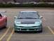 1993 Ford Probe - A light blue 1993 Ford Probe is parked in a lot, showing its front end and a black hood.