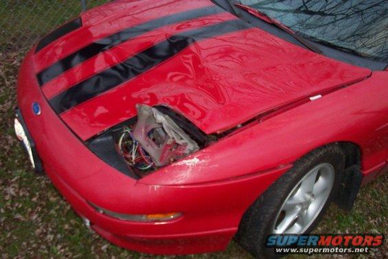 1993 Ford Probe front end with black hood stripes and missing headlight assembly