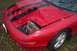 1993 Ford Probe - Front view of a red 1993 Ford Probe showing damage to the headlight area and hood.