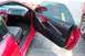 1993 Ford Probe - The interior of a red sports car is visible with the driver's side door ajar.