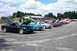 1993 Ford Probe - A row of Ford Probes are parked in a lot, most with hoods or trunks open, under a partly cloudy sky.