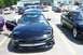 1993 Ford Probe - Two black Ford Probes are parked side-by-side in a parking lot on a sunny day.
