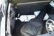 1993 Ford Probe - The trunk of a car contains a nitrous oxide tank, a guitar in a case, and other items.