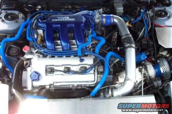 Engine bay with blue hoses and a V6 turbo intake manifold