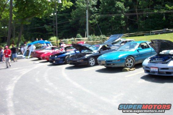 Several Ford Probe cars parked in a row, some with hoods open