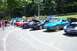 1993 Ford Probe - A line of Ford Probe cars are parked outdoors at an event.