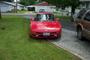 Red convertible parked in a driveway