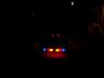 Red and blue police light bar with amber lights in the center