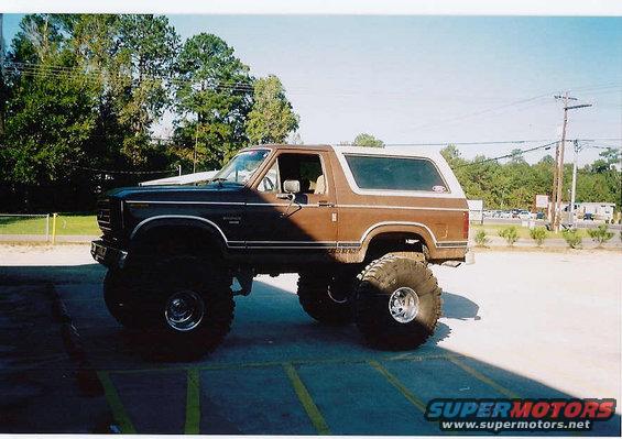 Brown lifted Ford Bronco with large tires parked outside