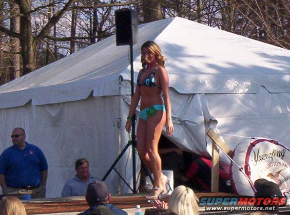 Woman in bikini on stage at outdoor event