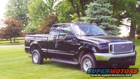 Black Ford F-250 truck parked on grass, front 3/4 view. Chrome grille and bumper visible