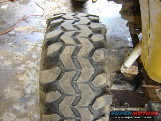 Close-up of a large off-road tire mounted on a vehicle