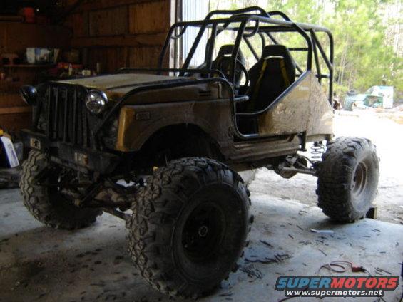 Off-road vehicle with roll cage and large tires, front 3/4 view