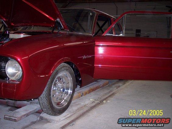 Red 1960 Ford Falcon, hood and driver door open, showing interior roll cage