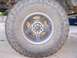 1994 Ford F-150 - A close-up view of a truck's wheel and tire, showing the tread pattern and rim.