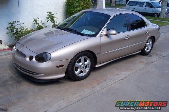 1998 Mercury Sable sedan, tan paint, aftermarket wheels, parked outdoors