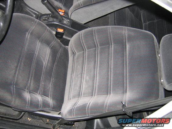 Front car seats with patterned fabric and seatbelts visible